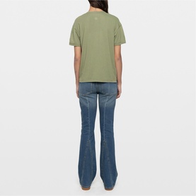 Model wearing Zadig green short-sleeve T-shirt, shown from behind, styled with mid-wash blue flared jeans.
