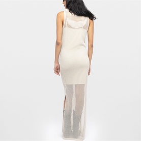 Model wearing Zadig beige sleeveless maxi dress with sheer panel skirt, shot from behind, midi-length silhouette with side split.
