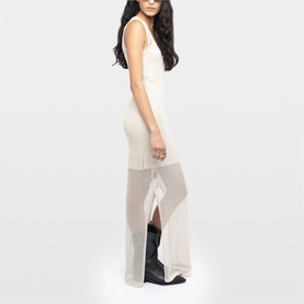 Model wearing Zadig beige sleeveless sheer maxi dress with front slit, styled with black knee-high boots