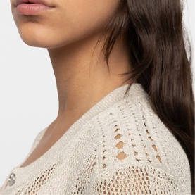 Model wearing Zadig beige open-knit crochet top, close-up detail shot showing textured stitch pattern at neckline and shoulder