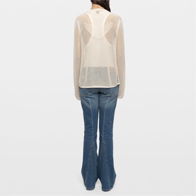 Model wearing Zadig beige sheer knit top, back view, styled with blue flare jeans