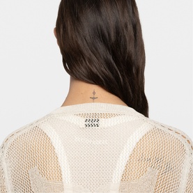 Model wearing Zadig beige open-knit mesh top, back view showing racerback detail and small neck tattoo graphic label.