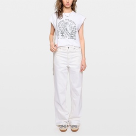 Model wearing Zadig white graphic print sleeveless t-shirt, styled with wide-leg white jeans and beige sandals