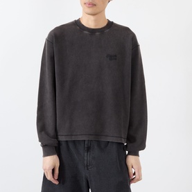 Model wearing Almost Home Porto Black oversized cotton crew neck sweatshirt with tonal chest patch, styled with dark trousers