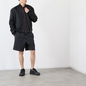 Model wearing Almost Home Porto Black T-shirt, styled with black bomber jacket, black shorts, and black trainers.
