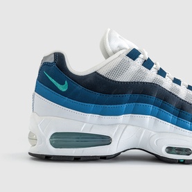 Nike Air Max 95 trainer in white, emerald green and lake blue, mesh and suede upper, visible Air unit, close-up heel and side detail