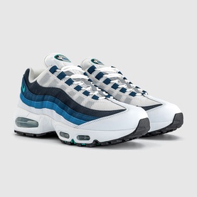 Nike Air Max 95 trainers in white, emerald green and lake blue, with visible Air unit, suede and mesh upper, and dark rubber sole.