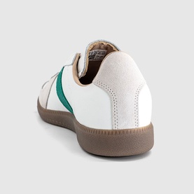 Adidas trainer in white with green heel stripe, tan gum sole, rear three-quarter view showing suede and leather panelling