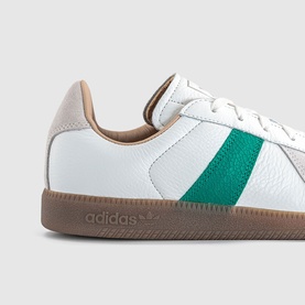 Adidas trainer in white and power green, tumbled leather upper, green stripe detail, gum rubber sole, beige heel tab.