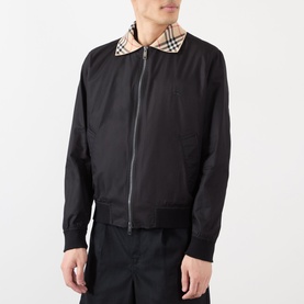 Model wearing Burberry Glenfields Harrington Jacket in black with signature check collar, two-way zip, ribbed cuffs, styled with black trousers