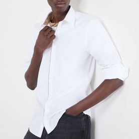 Model wearing Burberry Sam Logo Check Trim Casual Shirt in optic white with check piping detail, paired with dark grey jeans.