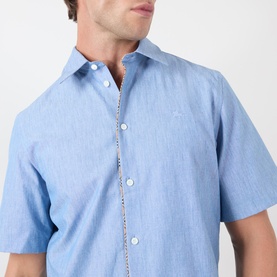 Model wearing Burberry Sam Check Trim Shirt in Stoke Blue Melange, showing embroidered logo and signature check trim on placket.