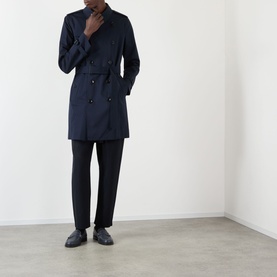 Model wearing Burberry Kensington Heritage Trench Coat in coal blue, double-breasted, belted longline with epaulettes, styled with black trousers and
