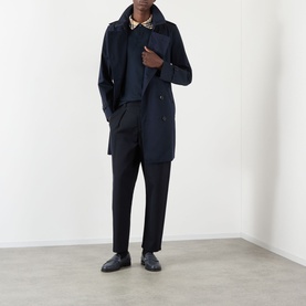 Model wearing Burberry Kensington Heritage Trench Coat in coal blue, double-breasted, with dark tailored trousers and black loafers.
