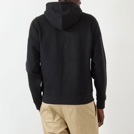 Model wearing Burberry Scott Embroidered Logo Zip Hoodie in black, rear view, with contrast piping detail, styled with beige trousers.