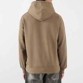 Model wearing Burberry finch brown cotton hoodie, back view, styled with distressed blue jeans