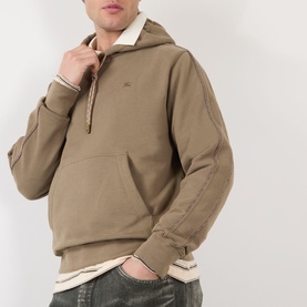 Model wearing Burberry finch brown cotton hoodie with quarter-zip detail and kangaroo pocket, styled with light-wash jeans
