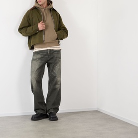 Model wearing Burberry Finch Brown cotton hoodie, styled with khaki overshirt, dark distressed jeans and black leather shoes.