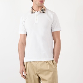 Model wearing Burberry white cotton polo shirt with Vintage Check collar, styled with beige chinos.