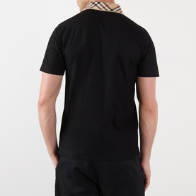 Model wearing Burberry black cotton polo shirt, back view, styled with matching black shorts and Burberry check scarf