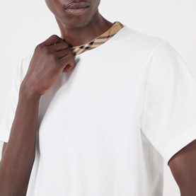 Model wearing Burberry Ryan Signature Check T-Shirt in white, close-up showing signature check taping trim at crew neckline