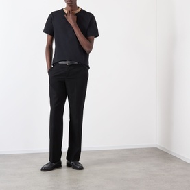 Model wearing Burberry Ryan Signature Check T-Shirt in black, crew neck, short sleeves, styled with black trousers and leather shoes.
