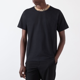 Model wearing Burberry Ryan Signature Check T-Shirt in black with signature check crew neck trim, styled with black trousers.