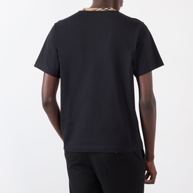 Model wearing Burberry Ryan Signature Check T-Shirt in black, rear view showing signature check taping at crew neckline, short sleeves, cotton jersey.