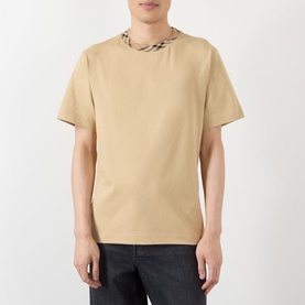 Model wearing Burberry Ryan Check-Collar T-Shirt in sand, featuring signature check neckline detail, paired with dark jeans.