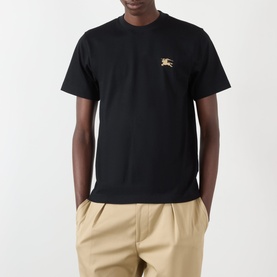 Model wearing Burberry Seth Embroidered Logo T-Shirt in black with EKD chest emblem, styled with khaki trousers.