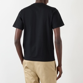 Model wearing Burberry Seth Embroidered Logo T-Shirt in black, rear view, styled with beige trousers.