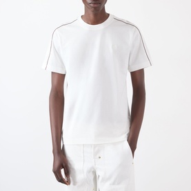 Model wearing Burberry Seth Logo Check T-Shirt in white with signature check piping trim on shoulders, styled with white trousers