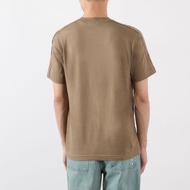 Model wearing Burberry Seth Check Piping T-Shirt in Finch Brown, back view showing check piping at shoulder seams, styled with light blue jeans.