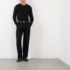 Model wearing Burberry black wool V-neck jumper with contrast trim neckline, styled with black tailored trousers and leather belt.