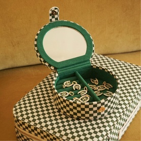 Daisy Jewellery Shrimps Compact Jewellery Case in green checkerboard cotton, open to reveal green faux suede interior, compartments with jewellery