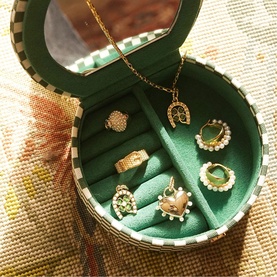 Daisy Jewellery Shrimps Compact Jewellery Case in green, checkerboard print, open to reveal velvet interior with assorted gold jewellery and mirror