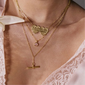 Model with Daisy Jewellery Healing Stone Necklace in 18ct Gold Plate, featuring round rose quartz pendant on adjustable chain, styled with layered