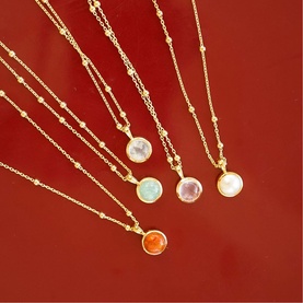 Daisy Jewellery Healing Stone Necklaces in 18ct gold plate, five round gemstone pendants in pink, white, green, orange, and pearl on bobble chains.