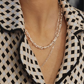 Model with Daisy Jewellery Polly Knot Chain Necklace in sterling silver, bold knot links, layered with a second chain necklace