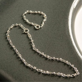 Daisy Jewellery Polly Knot Chain Necklace in sterling silver with bold knot links and classic clasp, shown with matching bracelet