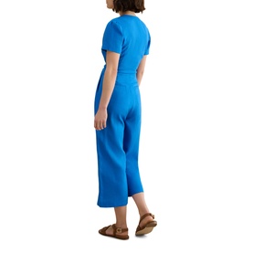 Model wearing Hobbs sapphire blue short-sleeve wrap jumpsuit with cropped wide-leg trousers, styled with tan flat sandals