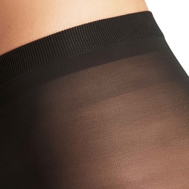 Falke black tights close-up showing sheer leg panel and wide elasticated waistband detail.