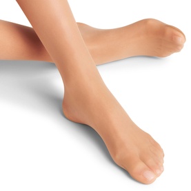 Model wearing Falke tights in Powder, a sheer nude tone, shown from the ankle and foot area against a white background.