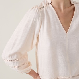 Model wearing InWear vanilla blouse with V-neckline, puff sleeves, and lace trim detailing on sleeve panels.