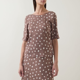 Model wearing InWear Henrii Polka Dot Blouse in Brown Bru, round neckline, half-length sleeves, white polka dot pattern, paired with matching skirt.