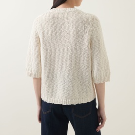 Model wearing InWear Dafne Textured Cardigan in Vanilla, showing back view with short sleeves, ribbed trims, and chunky knit texture, styled with