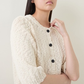 Model wearing InWear Dafne Textured Cardigan in Vanilla, cropped view showing round neckline, dark front buttons and ribbed trims