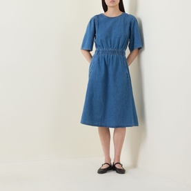Model wearing InWear Glenn Denim Dress in Faded Blue, midi-length with elasticated waist, wide short sleeves and flared skirt, styled with black flat