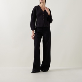 Model wearing InWear black jacket with V-neck and button front, styled with matching black wide-leg trousers.