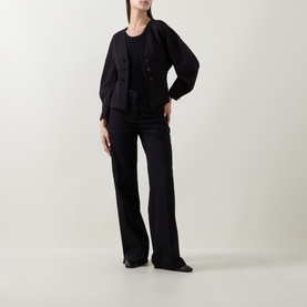 Model wearing InWear black jacket with balloon sleeves and button front, styled with matching black wide-leg trousers and black shoes.